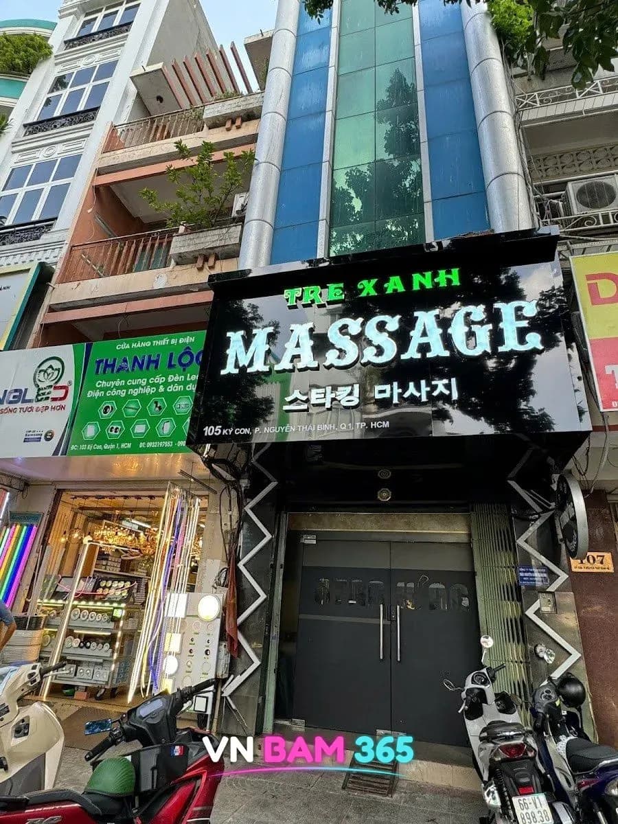 호치민 1군 Ký Con 거리 105번지 스타킹 마사지 외관, 검은 간판에 MASSAGE 조명 글자와 한글 스타킹 마사지 표기, 검은 양문 입구